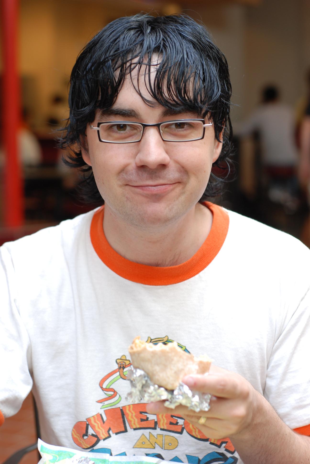 christian with a burrito || NIKON D80/50mm f/1.8@50 | 1/40s | f3.5 | ISO200 || 2007-07-15 14:32:32