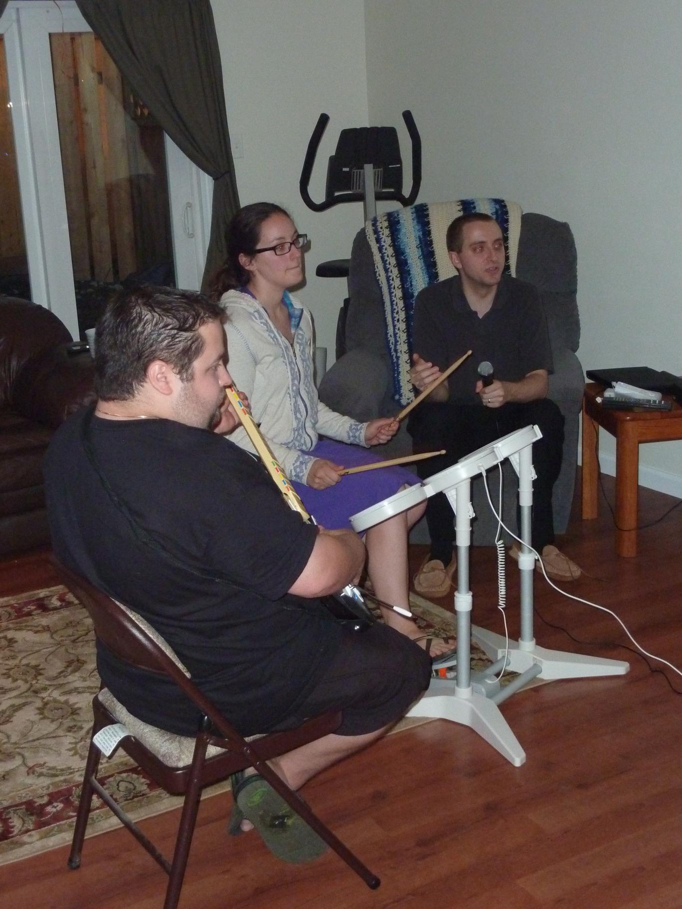 Brad, Sarah, and Justin playing Rock Band || DMC-ZS3@7.9 | 1/30s | f3.8 | ISO640 || 2010-06-12 23:00:49