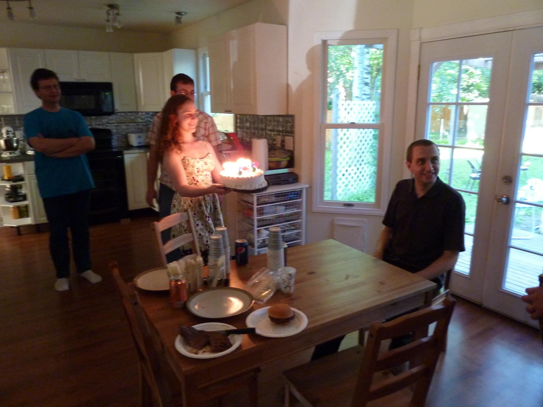 Shawna serving Justin a birthday cake || DMC-ZS3@4.1 | 1/8s | f3.3 | ISO400 || 2010-06-12 21:33:47